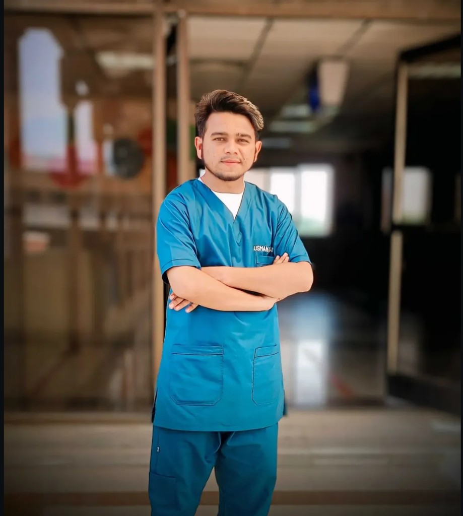 Usman Saleem wearing teal clinical scrubs